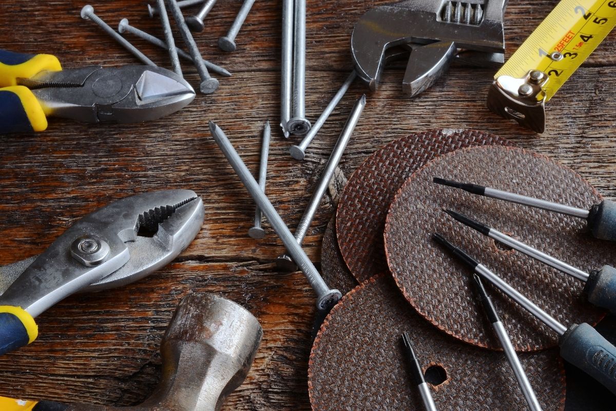 A wooden table displaying various tools, including a ruler and pliers, arranged neatly for easy access.